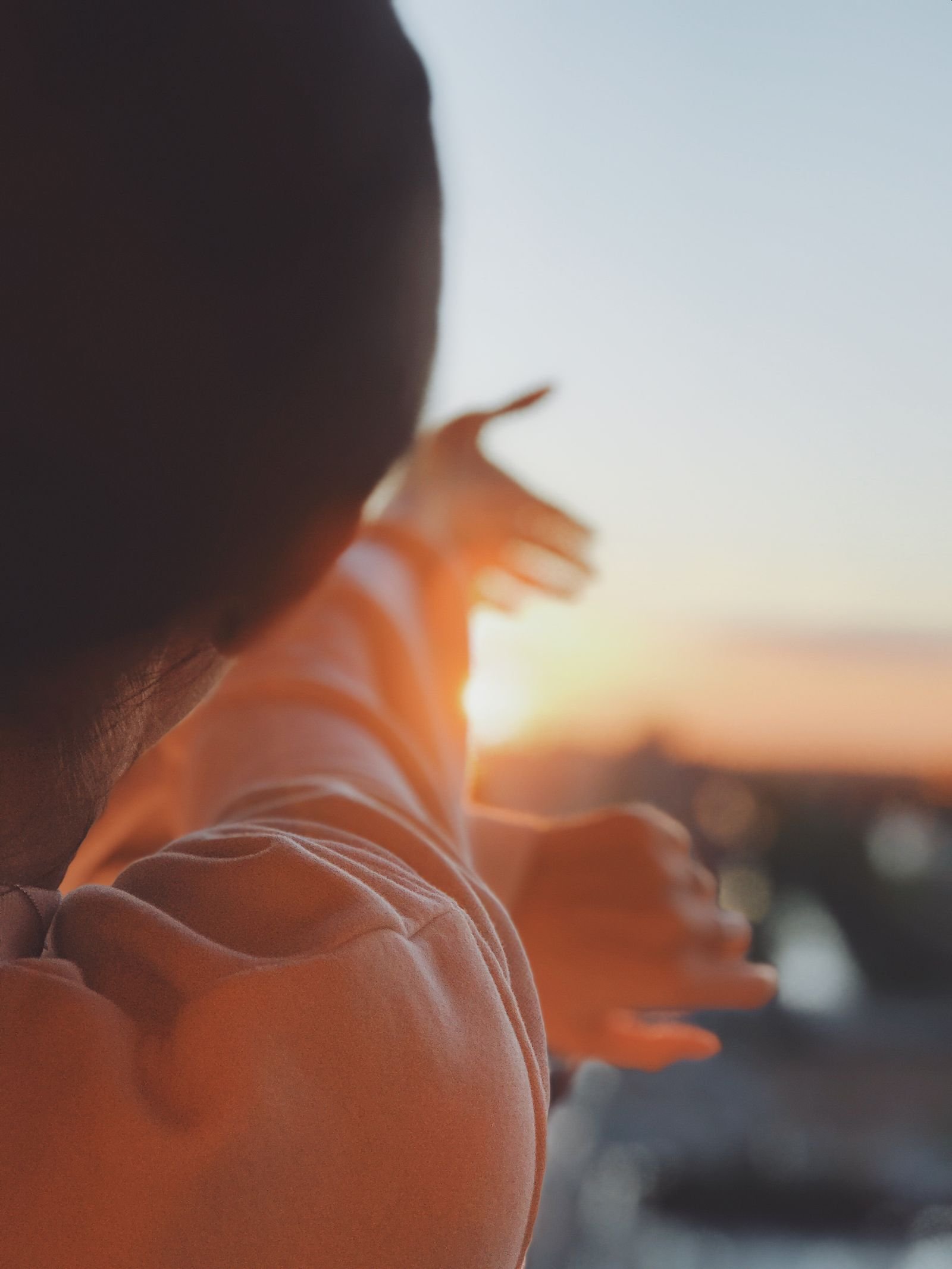 Woman reaching her hands toward the sun